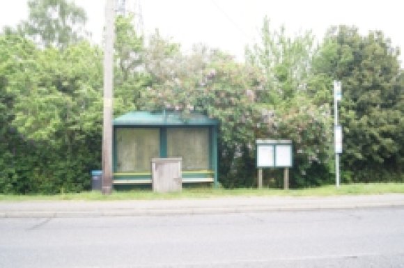 Picture of bus shelter Eastbound on London Road in Dunkirk Near the Courtenay Road entrance , with the Village Noticeboard to the right