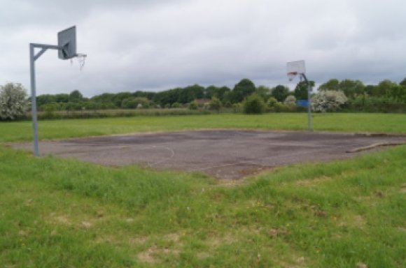 Picture of the Dunkirk playing field showing the Basketball Court and Hoops